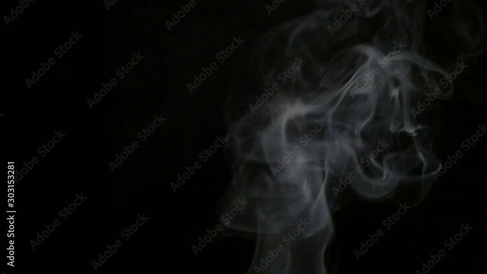 Smoke in slow motion on black background. White smoke slowly floating through space against black background Smoke in slow motion on black background. White smoke slowly floating through space against black background