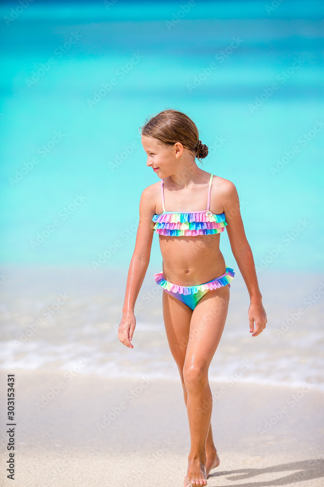 Adorable little girl on the beach during summer vacation Adorable little girl on the beach during summer vacation