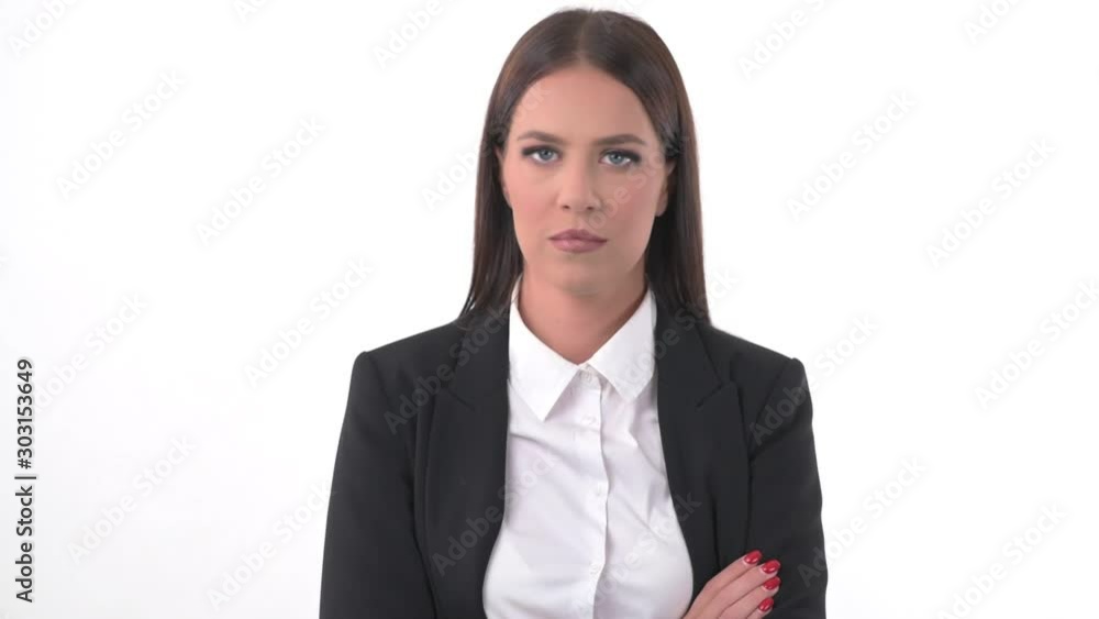 Displeased serious young pretty business woman shaking head with disapproval and refusal. Headshot portrait over white studio background. Displeased serious young pretty business woman shaking head with disapproval and refusal. Headshot portrait over white studio background.
