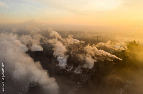 Fototapeta Naklejka Na Ścianę i Meble -  Aerial view. Pipes Throwing Smoke in the Sky.