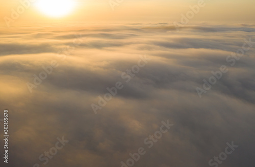 Flying over the evening clouds with the late sun. © Dmytro Kosmenko