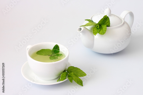 Mint tea in the cup near teapot 