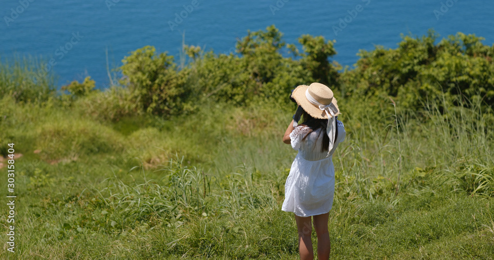 Woman take photo on camera at seaside Woman take photo on camera at seaside