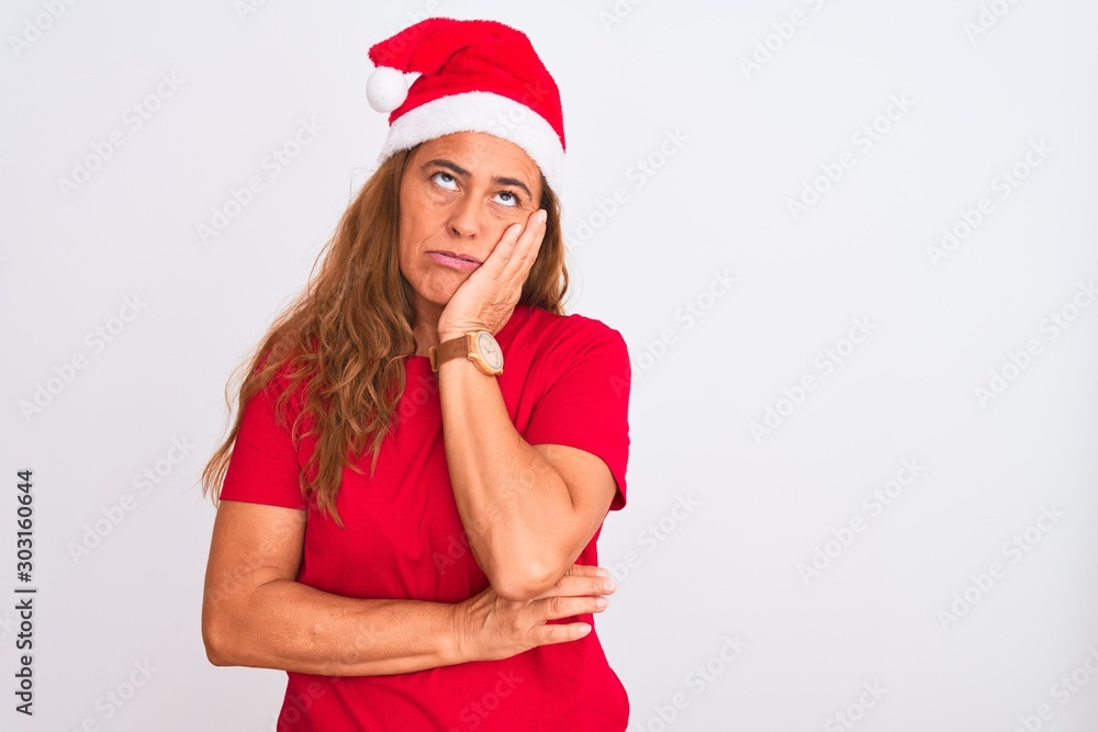 Middle age mature woman wearing christmas hat over isolated background thinking looking tired and bored with depression problems with crossed arms. Middle age mature woman wearing christmas hat over isolated background thinking looking tired and bored with depression problems with crossed arms.
