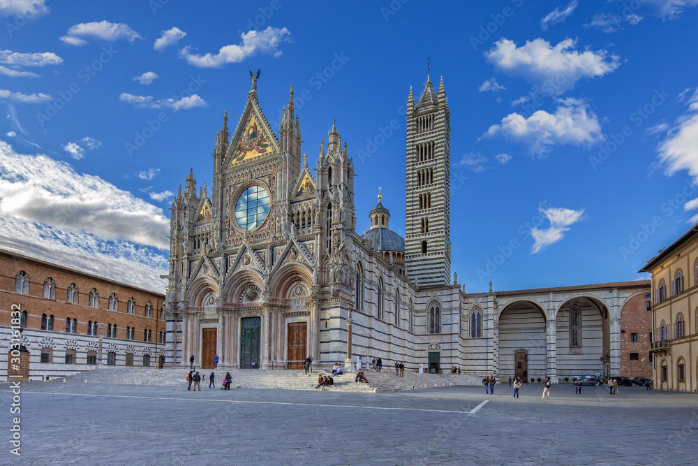 Tourists visit the Cathedral of Siena. Duomo di Siena is a romanesque-gothic cathedral it is a major tourism attraction in Siena, Tuscany, Italy