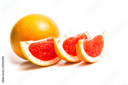 Orange-red grapefruit in a cut on a white background. close up