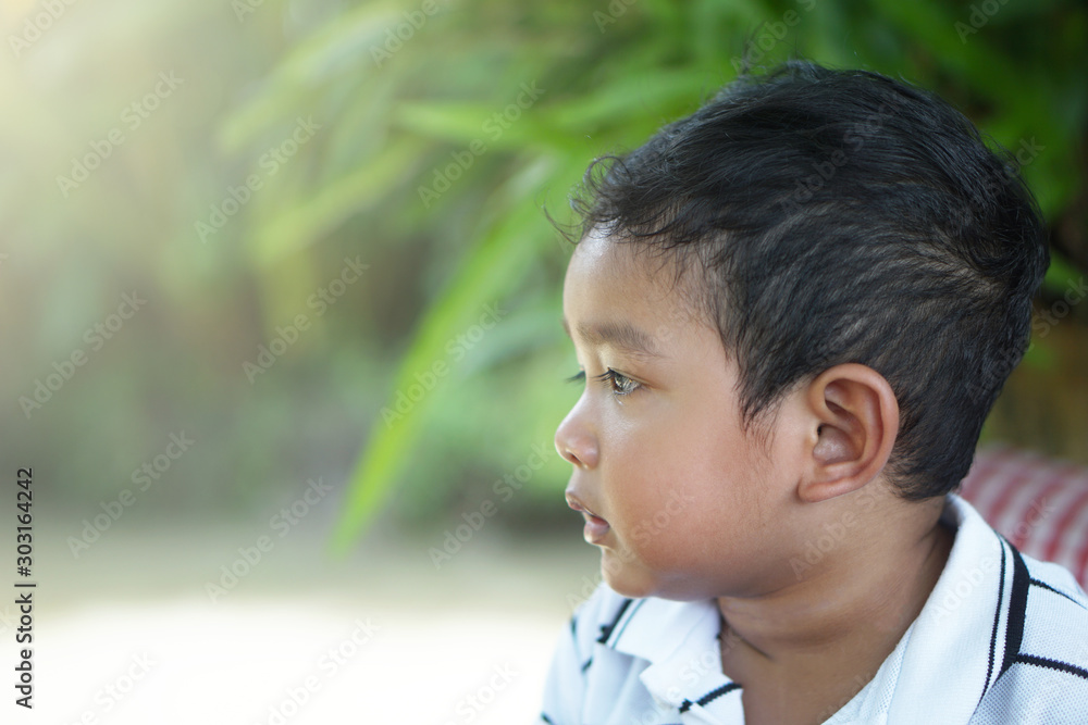 Cute little smiling Asian 20 months / 1.8 year old toddler baby boy child sitting and eating soft serve ice cream outdoor, Happy kid concept Cute little smiling Asian 20 months / 1.8 year old toddler baby boy child sitting and eating soft serve ice cream outdoor, Happy kid concept