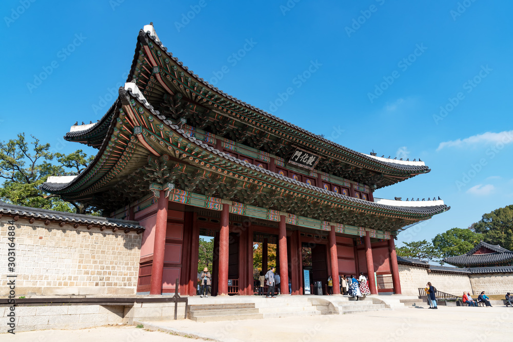 Tourists and visitors at the entrance of Changdeokgung palace, famous landmark in Seoul.