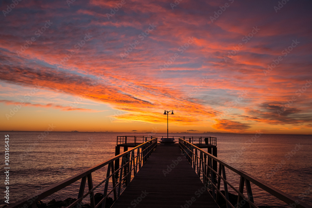  sunrise on the mediterranean sea with pier silhouette