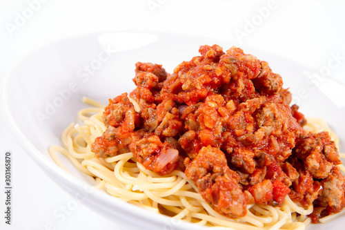 Spaghetti bolognese on a plate on a white background	