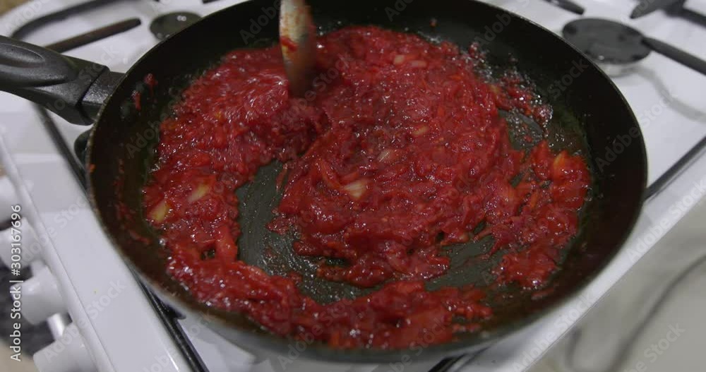 Saucepan with a homemade appetizing and tasty borsch. Red beetroot vegetable soup, boiling in pot. Ukrainian and russian traditional red beet soup - borscht or borsch Saucepan with a homemade appetizing and tasty borsch. Red beetroot vegetable soup, boiling in pot. Ukrainian and russian traditional red beet soup - borscht or borsch