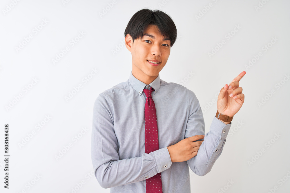 Chinese businessman wearing elegant tie standing over isolated white background with a big smile on face, pointing with hand finger to the side looking at the camera. Chinese businessman wearing elegant tie standing over isolated white background with a big smile on face, pointing with hand finger to the side looking at the camera.