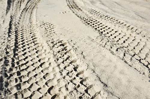 Earth mover tire tracks in sand quarry