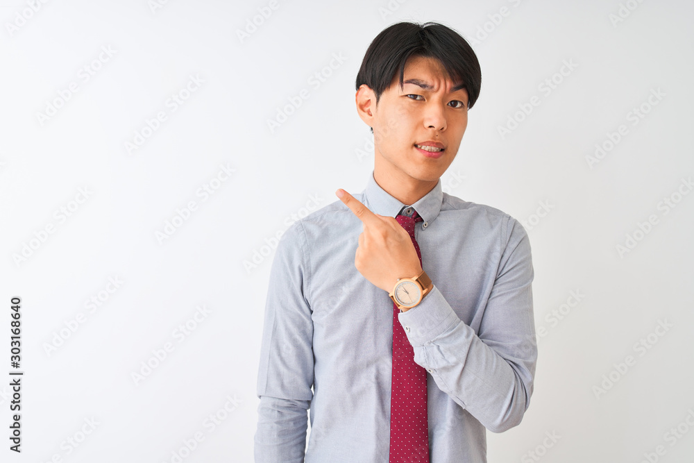 Chinese businessman wearing elegant tie standing over isolated white background Pointing aside worried and nervous with forefinger, concerned and surprised expression