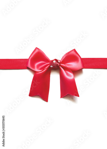 Red ribbon with bow on white. Holiday concept.