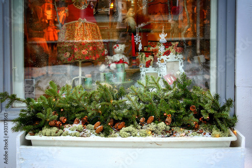 Festive Christmas border - green fir branches on the window. Porvoo oldtown, Finland