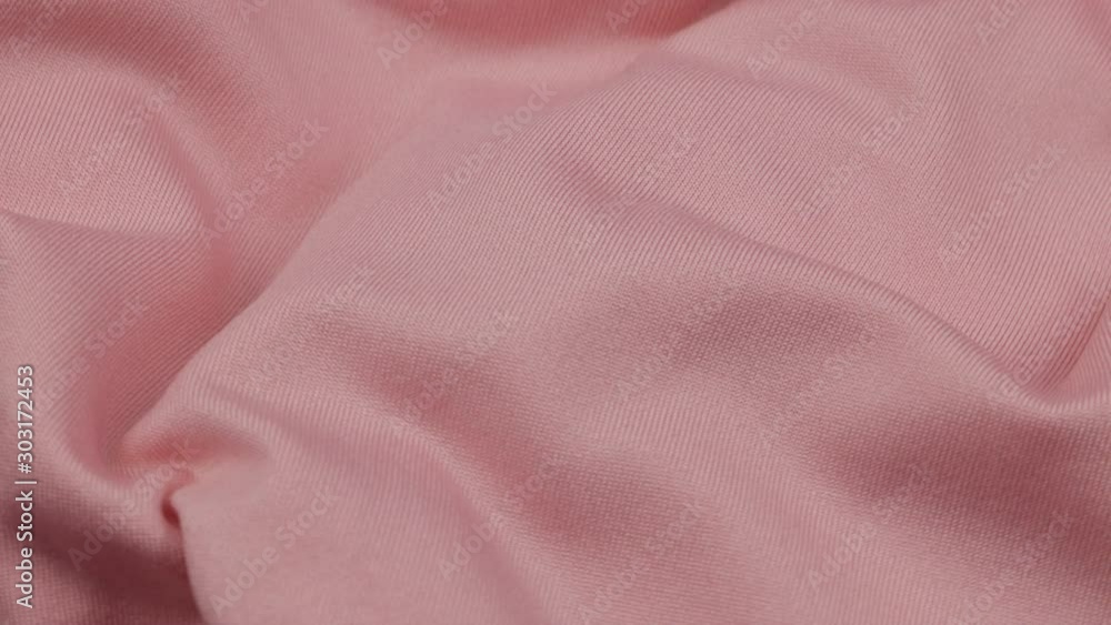 Pale pink velour is draped with soft pleats, background Pale pink velour is draped with soft pleats, background