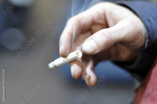 the man at the factory smokes a cigarette. Soft blur  defocus