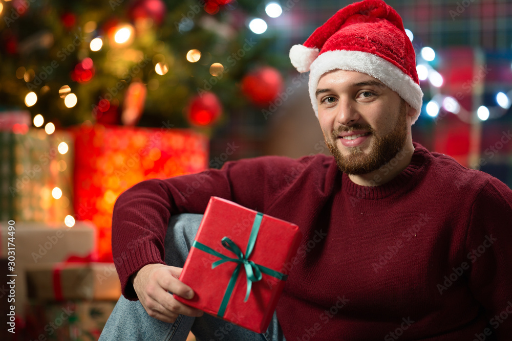 man with christmas gifts under the tree man with christmas gifts under the tree