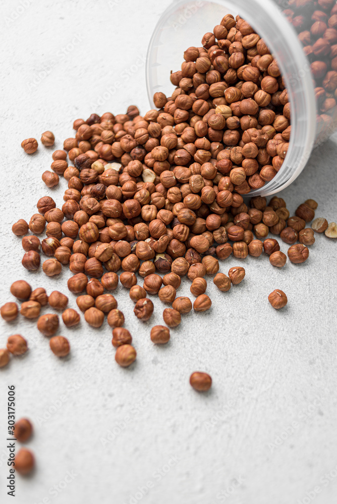 scattered hazelnuts on a light background scattered hazelnuts on a light background