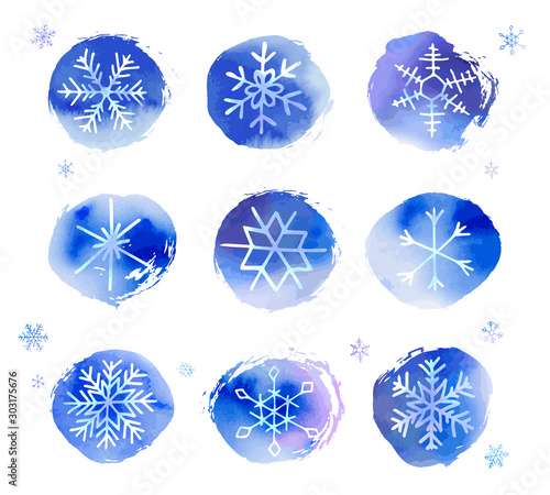 Collection of artistic blue snowflakes with watercolor texture. Stock vector set. Can be used for printed materials, prints, posters, cards, logo. Abstract background. Hand drawn decorative elements. 