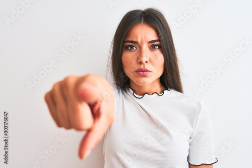 Wallpaper Mural Young beautiful woman wearing casual t-shirt standing over isolated white background pointing with finger to the camera and to you, hand sign, positive and confident gesture from the front Torontodigital.ca