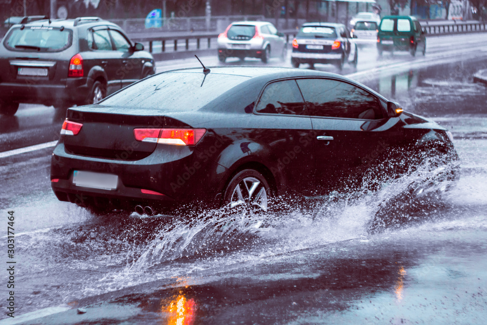 Ukraine. Kiev - 05,12,2019 Spraying water from the wheels of a vehicle ...