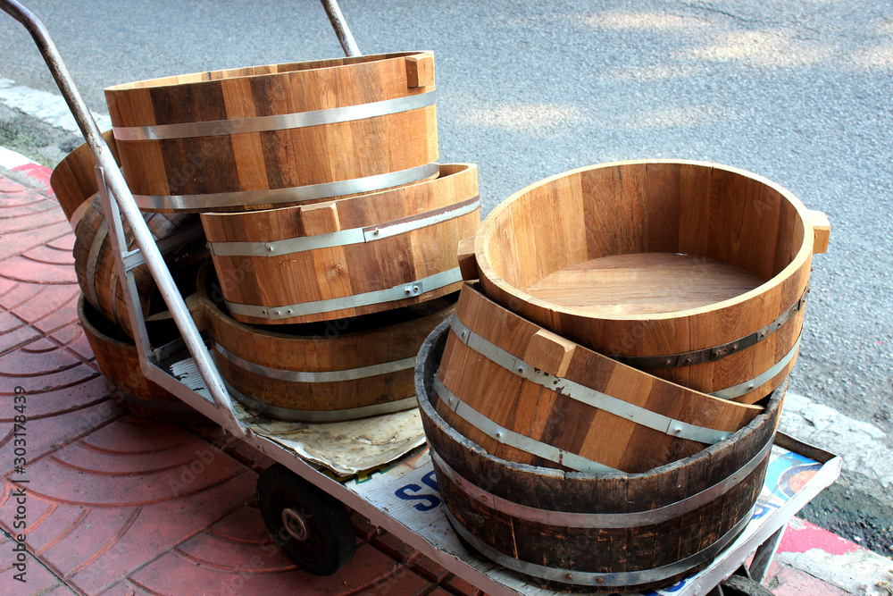 Wooden tubs placed on three wheeled cart Wooden tubs placed on three wheeled cart
