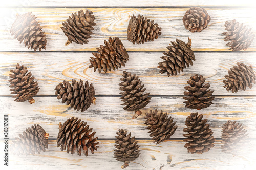 Christmas cones on a white wooden background