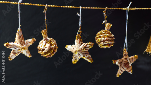 Christmas composition. Christmas gold decoration on dark gray background. Close-up