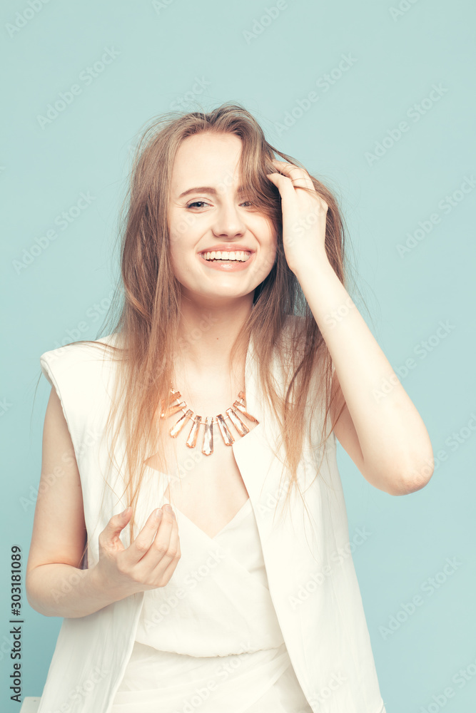 portrait of a beautiful young girl with long hair on a blue background portrait of a beautiful young girl with long hair on a blue background