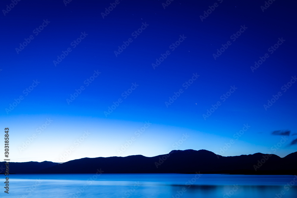 the night sky above loch linnhe in the argyll region of the highlands of scotland during a crisp blue autumn evening