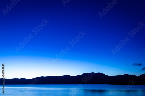 the night sky above loch linnhe in the argyll region of the highlands of scotland during a crisp blue autumn evening