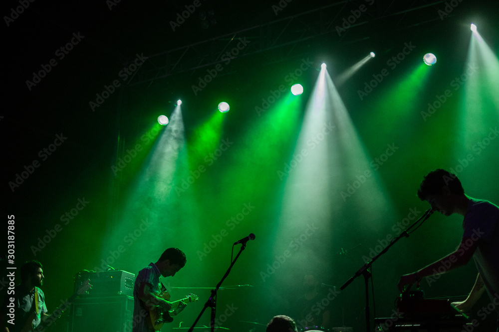  silhouettes of a music group playing live