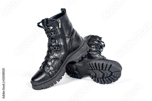 Boys and girls boots on light background with light shadow. All teens like this shoe, it is suitable for cold, wet weather, they are waterproof