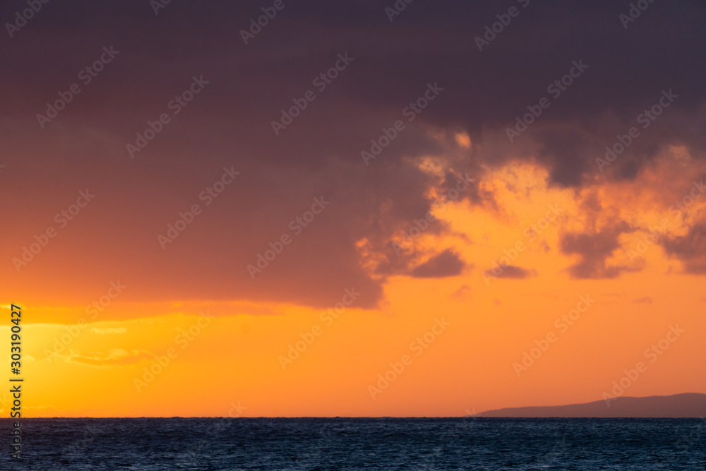 Colorful skies and clouds above ocean during sunset