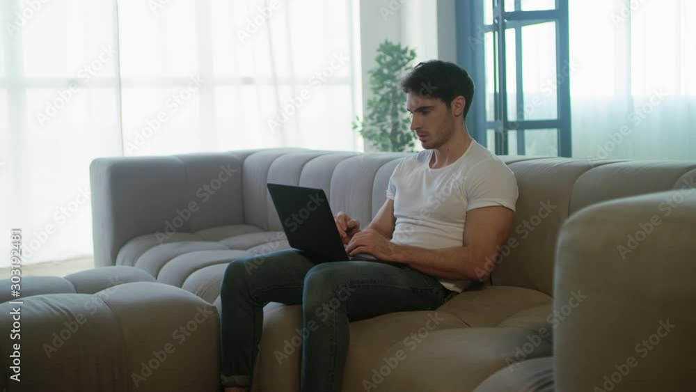 Upset freelancer man working laptop computer at remote workplace. Upset freelancer man working laptop computer at remote workplace.