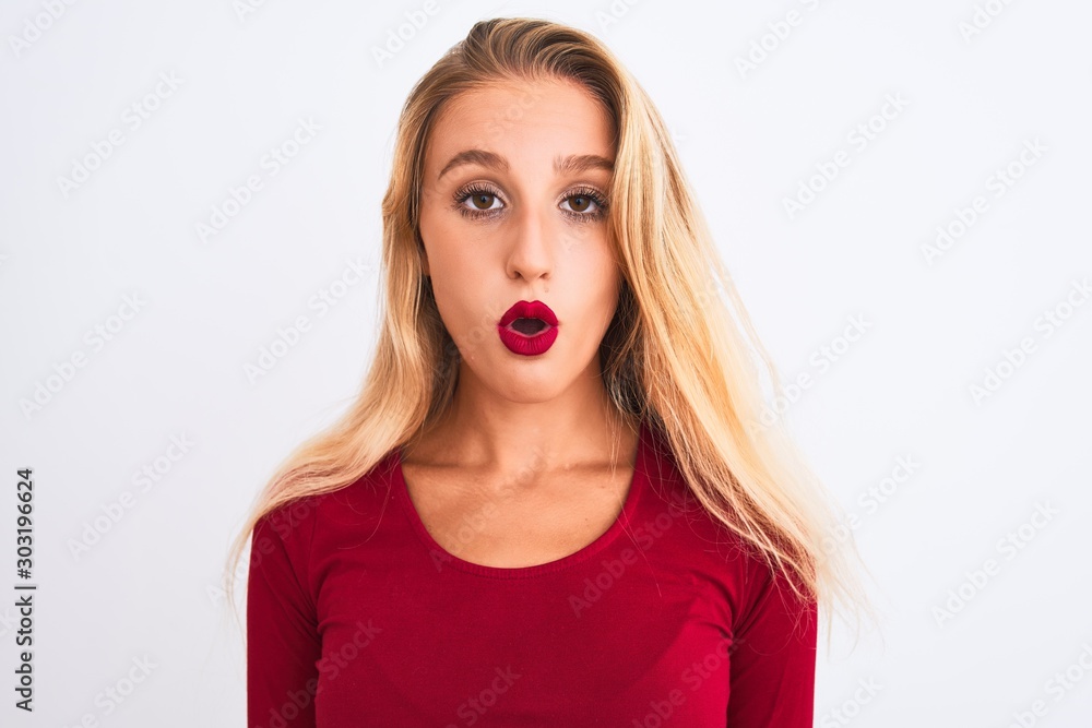 Young beautiful woman wearing red t-shirt standing over isolated white background scared in shock with a surprise face, afraid and excited with fear expression Young beautiful woman wearing red t-shirt standing over isolated white background scared in shock with a surprise face, afraid and excited with fear expression
