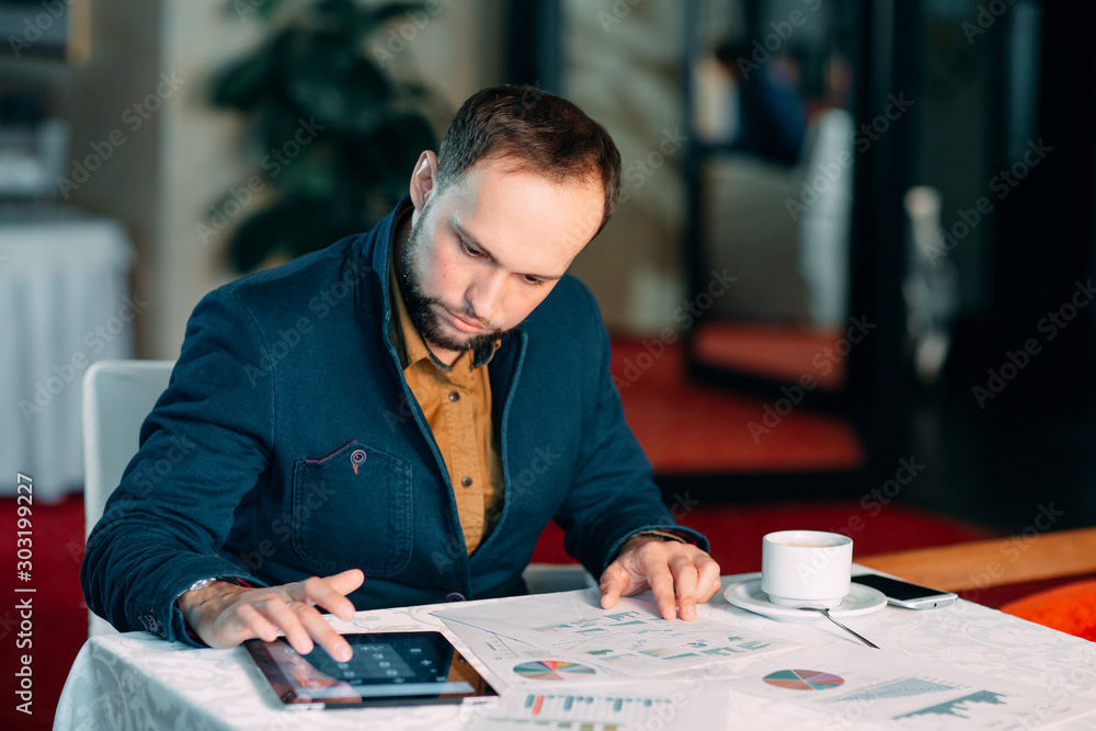 Fototapeta premium Man Working in Office and Analyzing Some Statistical Calculation Reports.