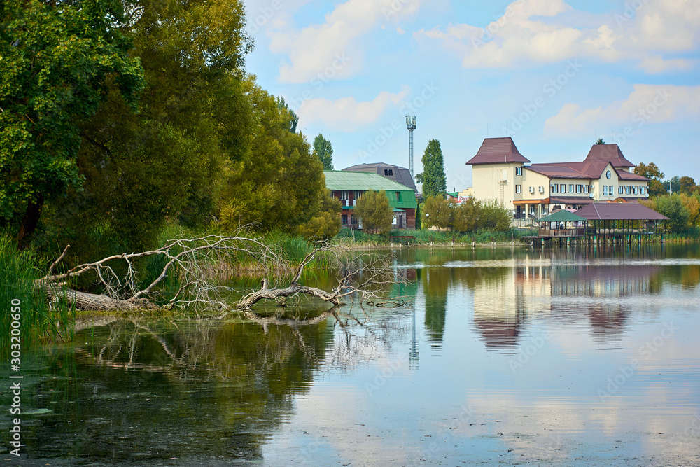 River house with reflections and blue sky near the forest