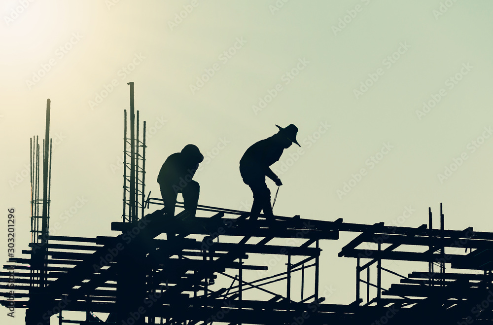 silhouette of workers on construction site