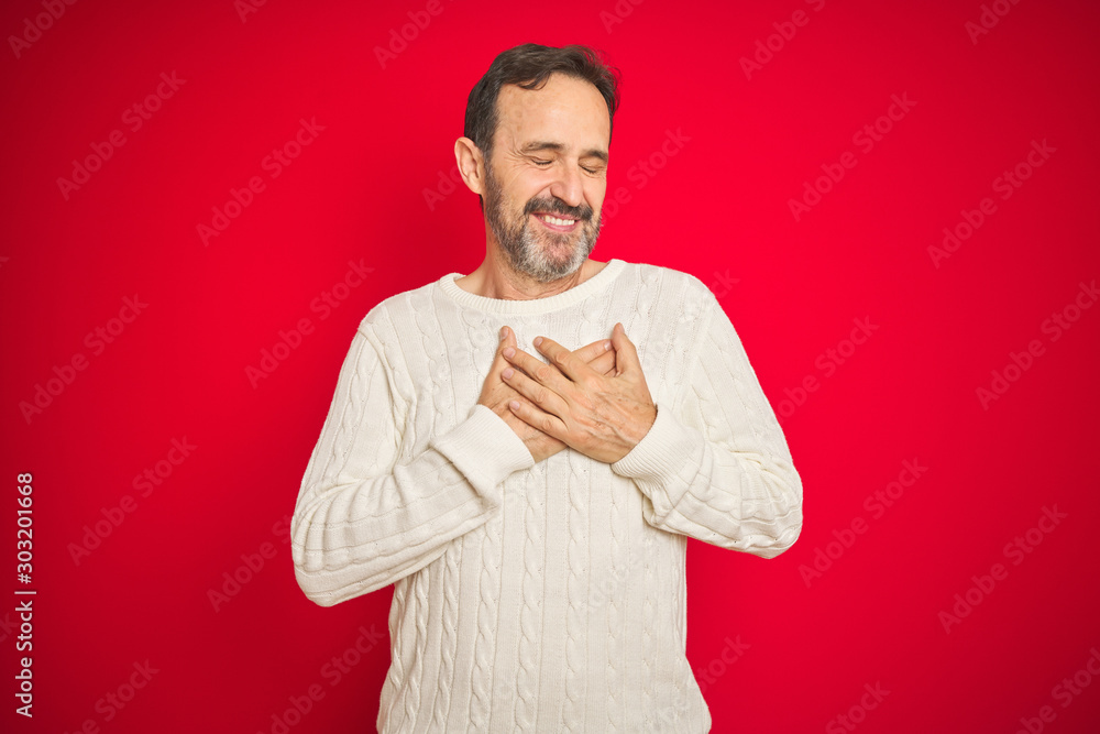 Handsome middle age senior man with grey hair over isolated red background smiling with hands on chest with closed eyes and grateful gesture on face. Health concept. Handsome middle age senior man with grey hair over isolated red background smiling with hands on chest with closed eyes and grateful gesture on face. Health concept.