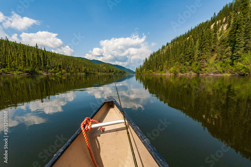 Fishing from canoe on Teslin river in Yukon, Canada