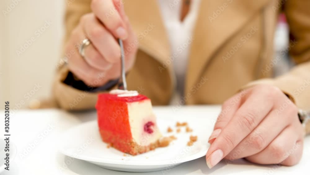 4k video of young woman eating cheesacake in cafe with fork 4k video of young woman eating cheesacake in cafe with fork