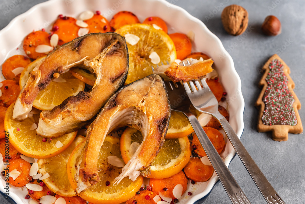 Fried carp fish slices with carrot and oranges. Traditional Polish Christmas eve dish. Fried carp fish slices with carrot and oranges. Traditional Polish Christmas eve dish.