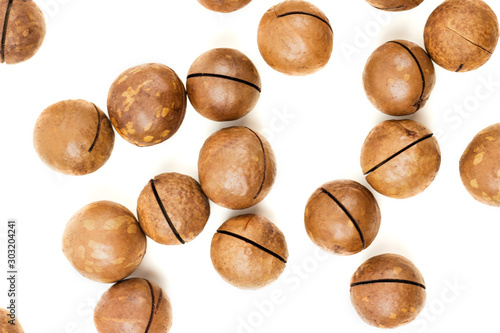 Raw not peeled whole macadamia nuts isolated on white
