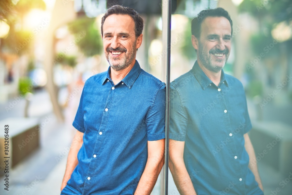 Middle age handsome man leaning on the wall smiling Middle age handsome man leaning on the wall smiling