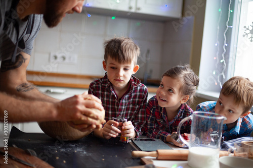 Young family making cookies at home