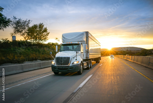 White semi-truck on the highway delivering freight photo