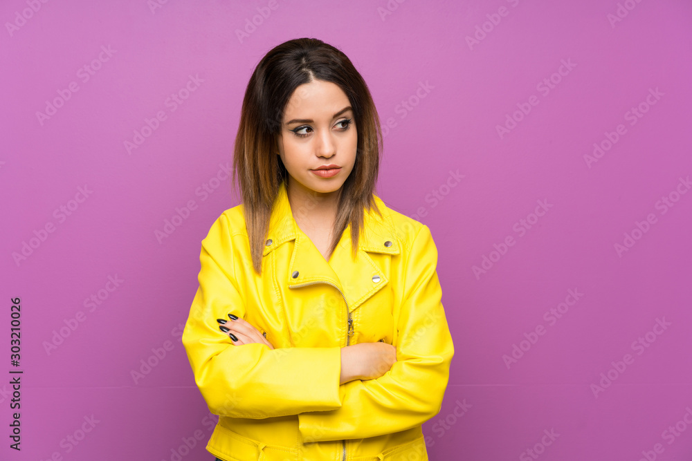 Young woman over purple background thinking an idea Young woman over purple background thinking an idea